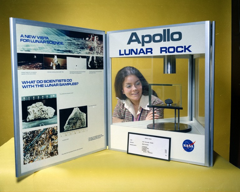 Miss NASA 1973 (Merri C. Fahnenbruck) with the Apollo lunar rock display